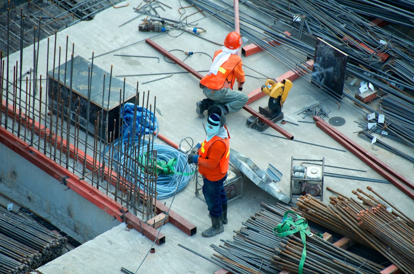Construction workers wearing safety equipment at an active work site
